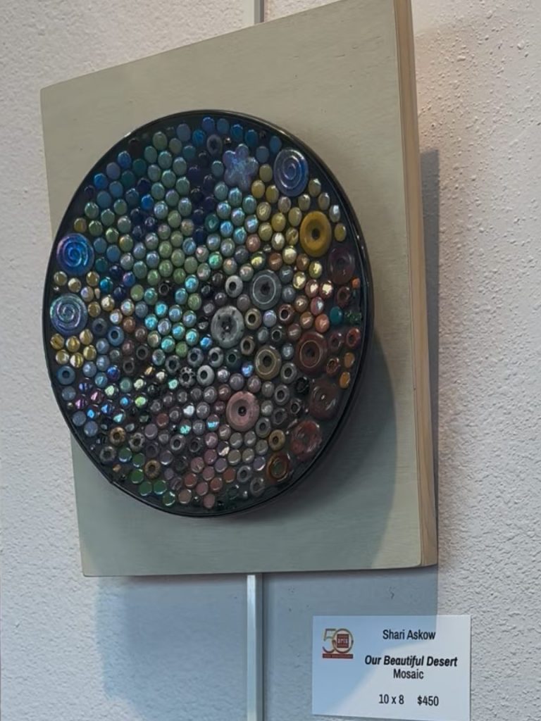 Our Beautiful desert Colorful circular artwork made of various small round mixed gemstones, and mixed media materials on a metal base, mounted on wood.